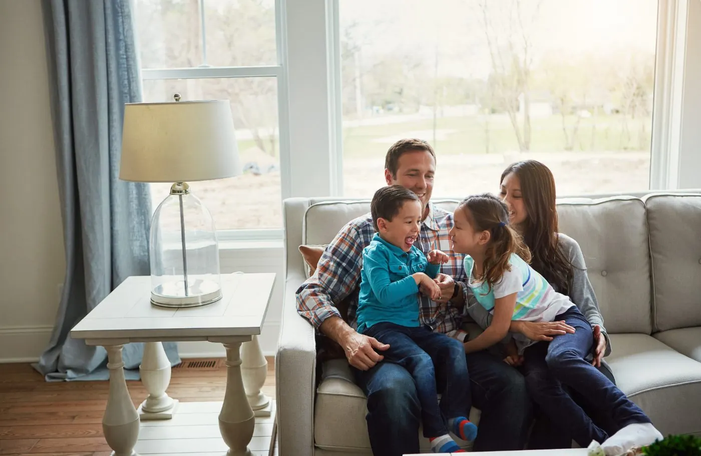 Family relaxing in the living room of their new home
