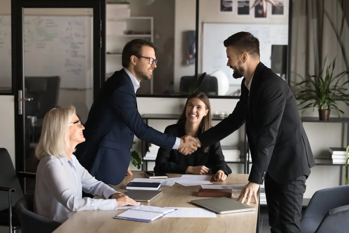 Closing handshake across the conference table